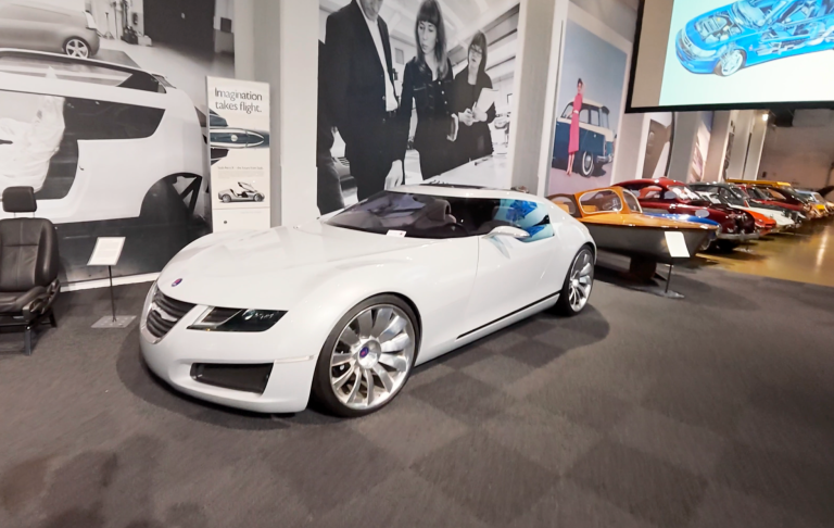 Saab Aero X på Saab Car Museum Vit sportbil med futuristisk design, framtagen av Saab, i en bilutställning.