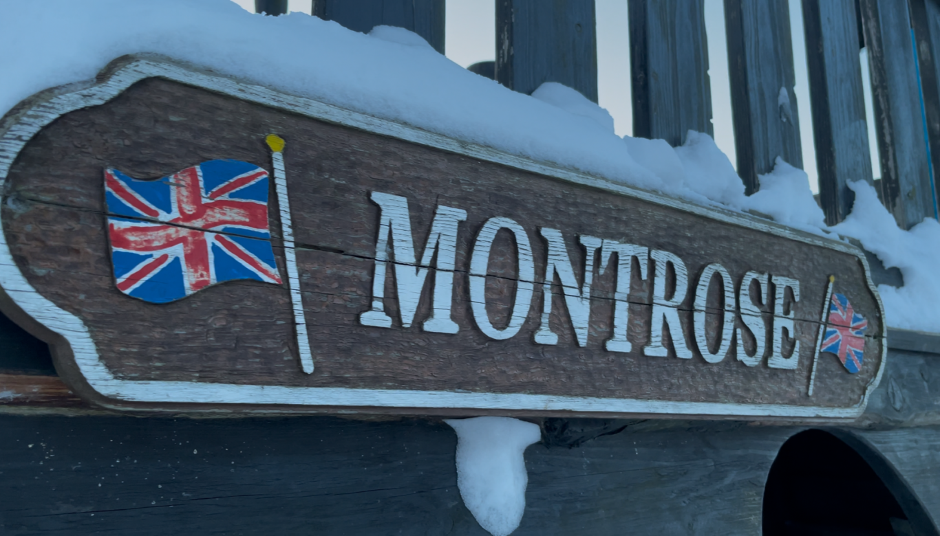 Skeppet Monterose Tjolöholms Slott Skylt med texten "Montrose" och två brittiska flaggor, omgiven av snö.